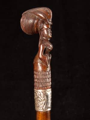 Victorian cane with a full carved wooden Lady wearing a bustle_a